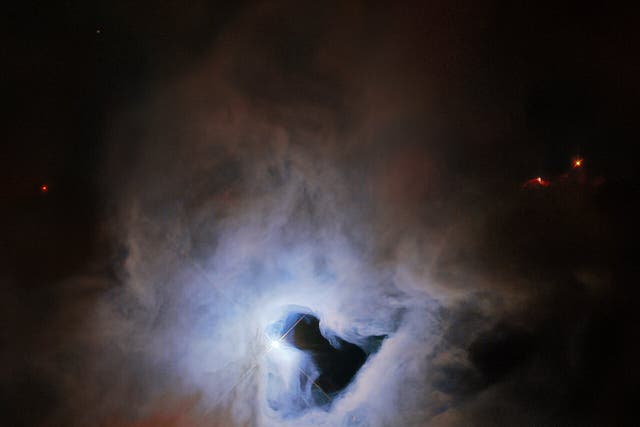 <p>The reflection nebular NGC 1999 lies about 1,350 light years from Earth in the constellation Orion, and exhibits an inky black central “keyhole” in this image taken by the Hubble Space Telescope</p>