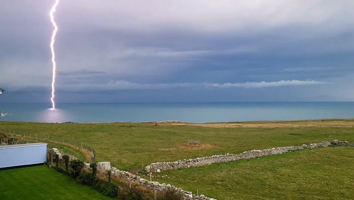 Lightning bolt strikes in sea off Dorset coast amid heavy rain and thunderstorms