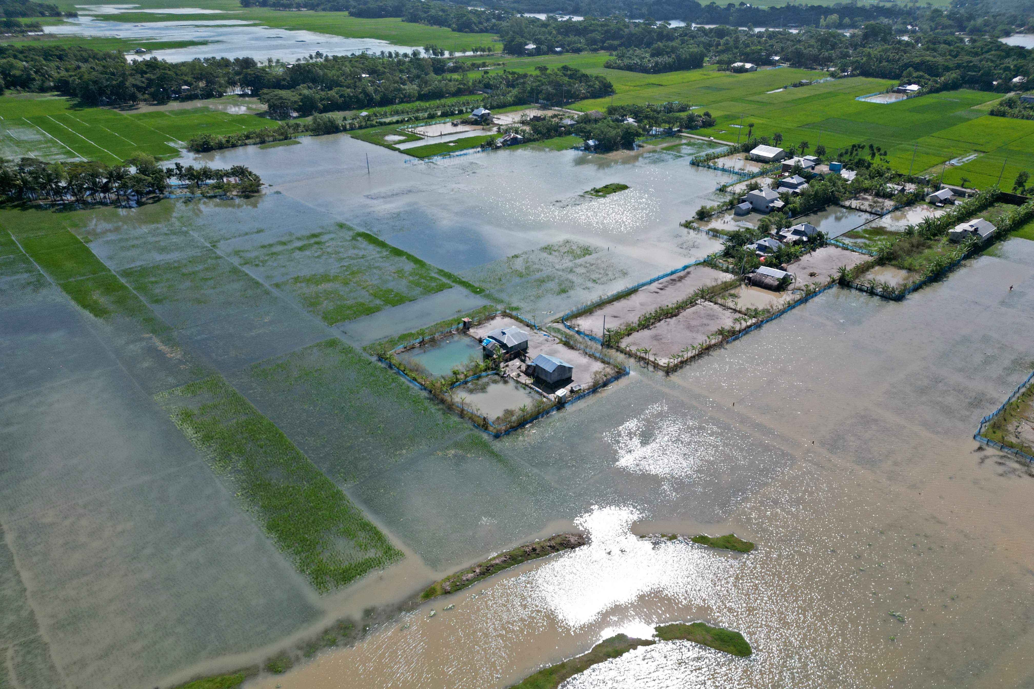 An aerial view shows flooded fields and houses after heavy rains in Kalapara on 25 October 2022