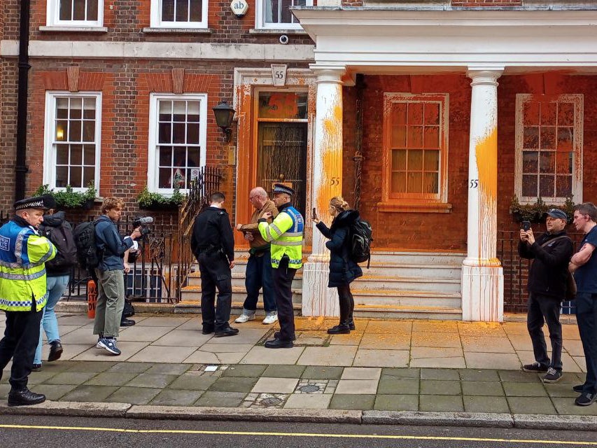 Two activists sprayed orange paint over the front of 55 Tufton Street in Westminster