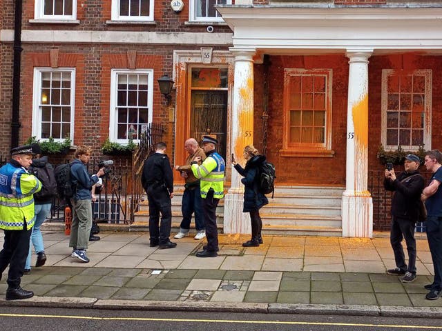 <p>Two activists sprayed orange paint over the front of 55 Tufton Street in Westminster, while others halted traffic and unfurled banners</p>