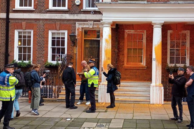 <p>Two activists sprayed orange paint over the front of 55 Tufton Street in Westminster, while others halted traffic and unfurled banners</p>