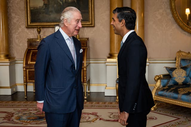 The King welcomes Rishi Sunak during an audience at Buckingham Palace where he invited the newly elected leader of the Conservative Party to become Prime Minister and form a new government (Aaron Chown/PA)