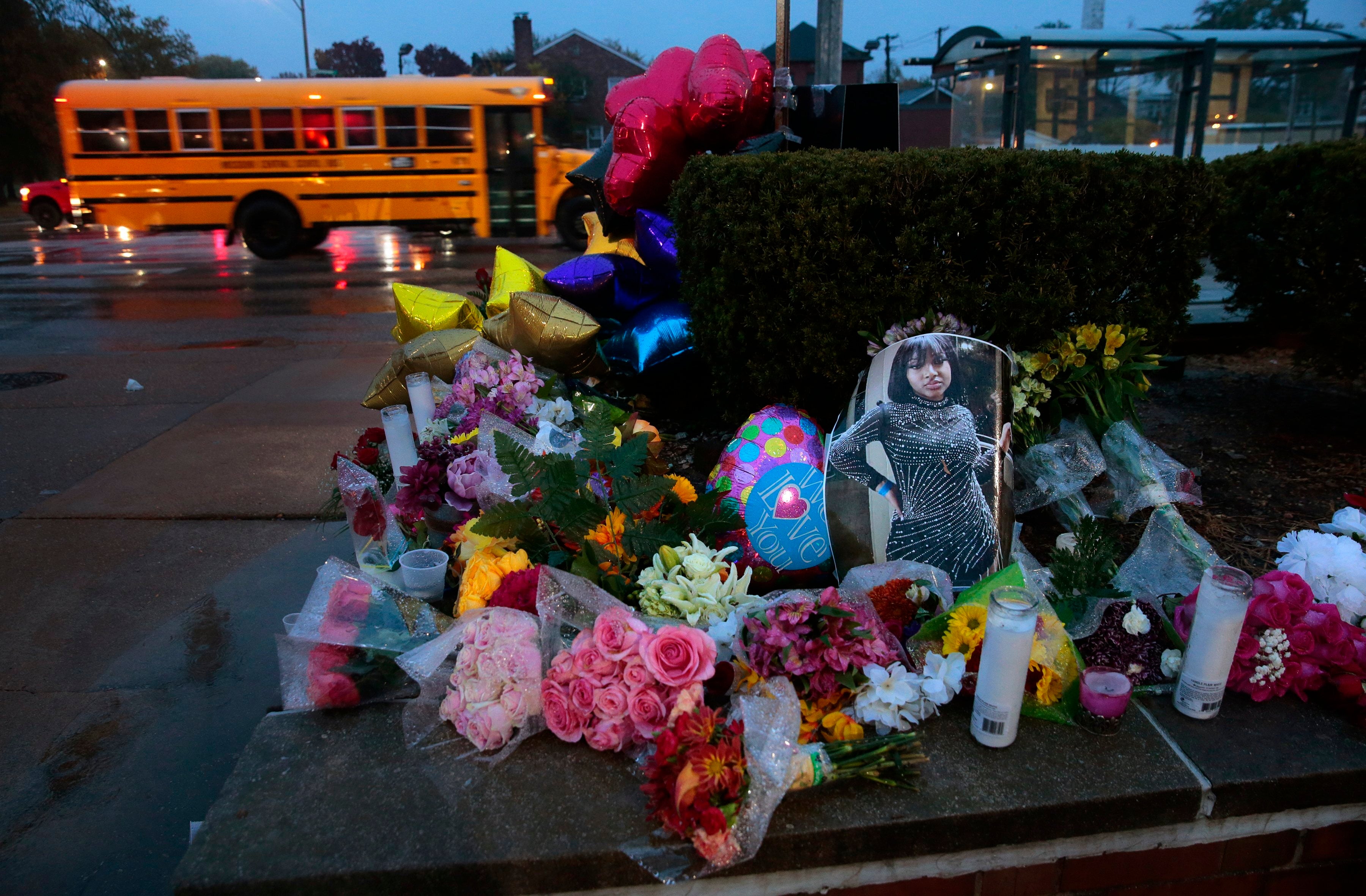 A photo of Alexandria Bell rests at the scene of a growing floral memorial to the victims of a school shooting at Central Visual & Performing Arts High School, Tuesday, Oct. 25, 2022, in St. Louis