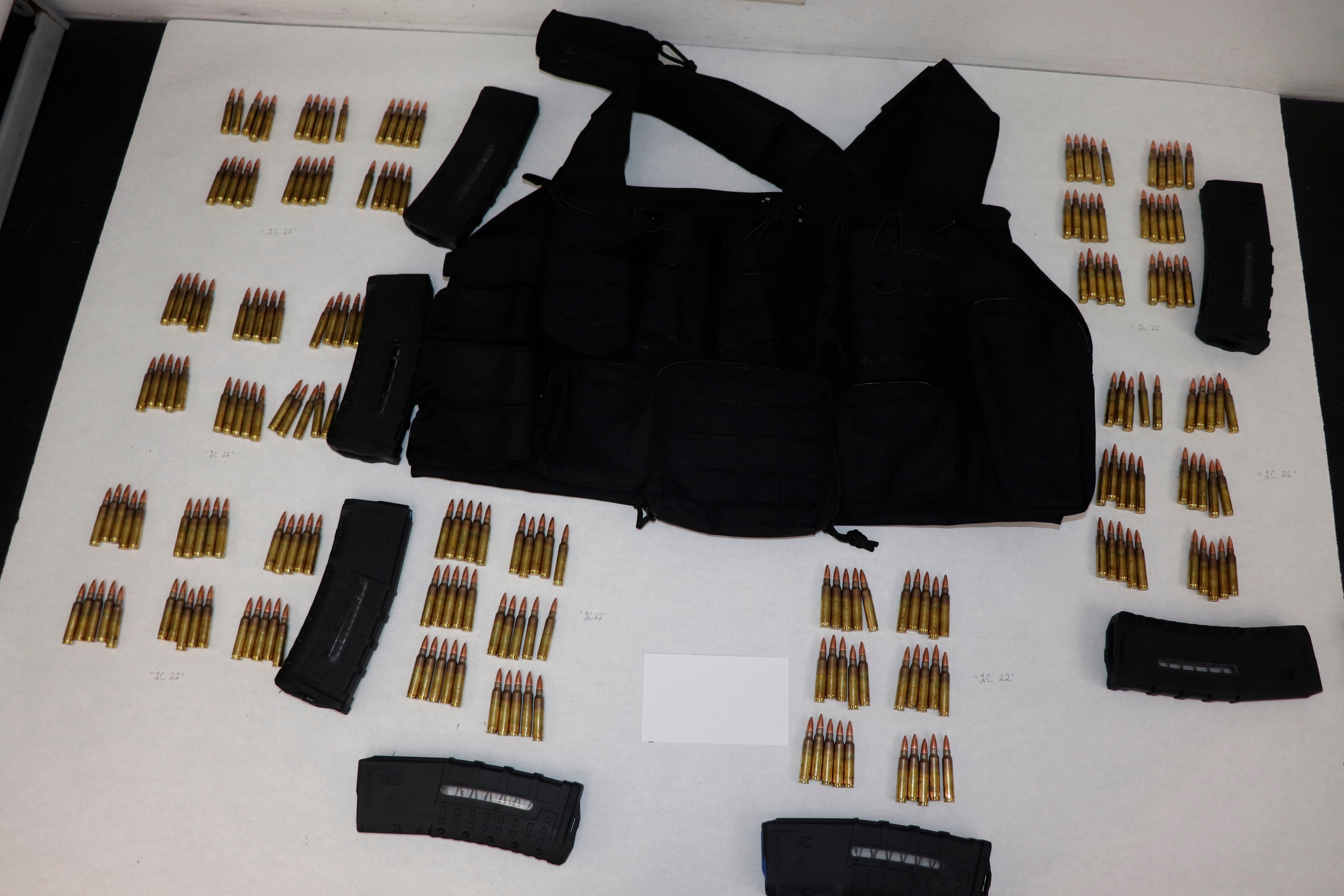 This image provided by the St. Louis Metropolitan Police Department shows ammunition, magazines and a vest used by a 19-year-old gunman who killed a teacher and a 15-year-old girl at a St. Louis high school on Monday, Oct. 24, 2022