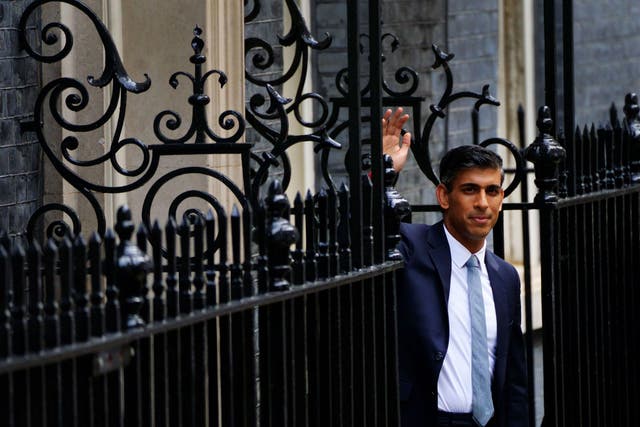 Rishi Sunak waves from the door of 10 Downing Street after becoming Prime Minister (Victoria Jones/PA)