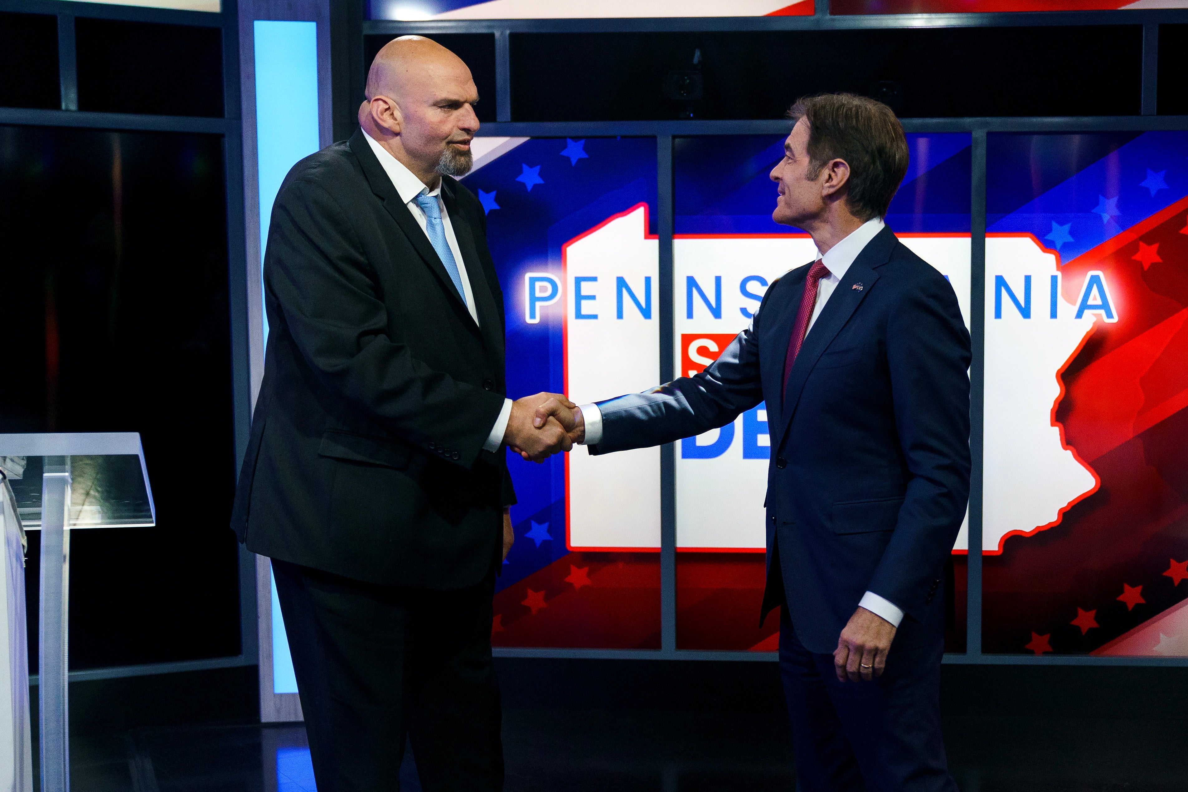 A handout photo made available by ABC27 shows Democratic candidate Lt. Gov. John Fetterman (left) and Republican Pennsylvania Senate candidate Dr Mehmet Oz (right) shaking hands prior to the Nexstar Pennsylvania Senate Debate at WHTM ABC27 in Harrisburg, Pennsylvania, USA, 25 October 2022