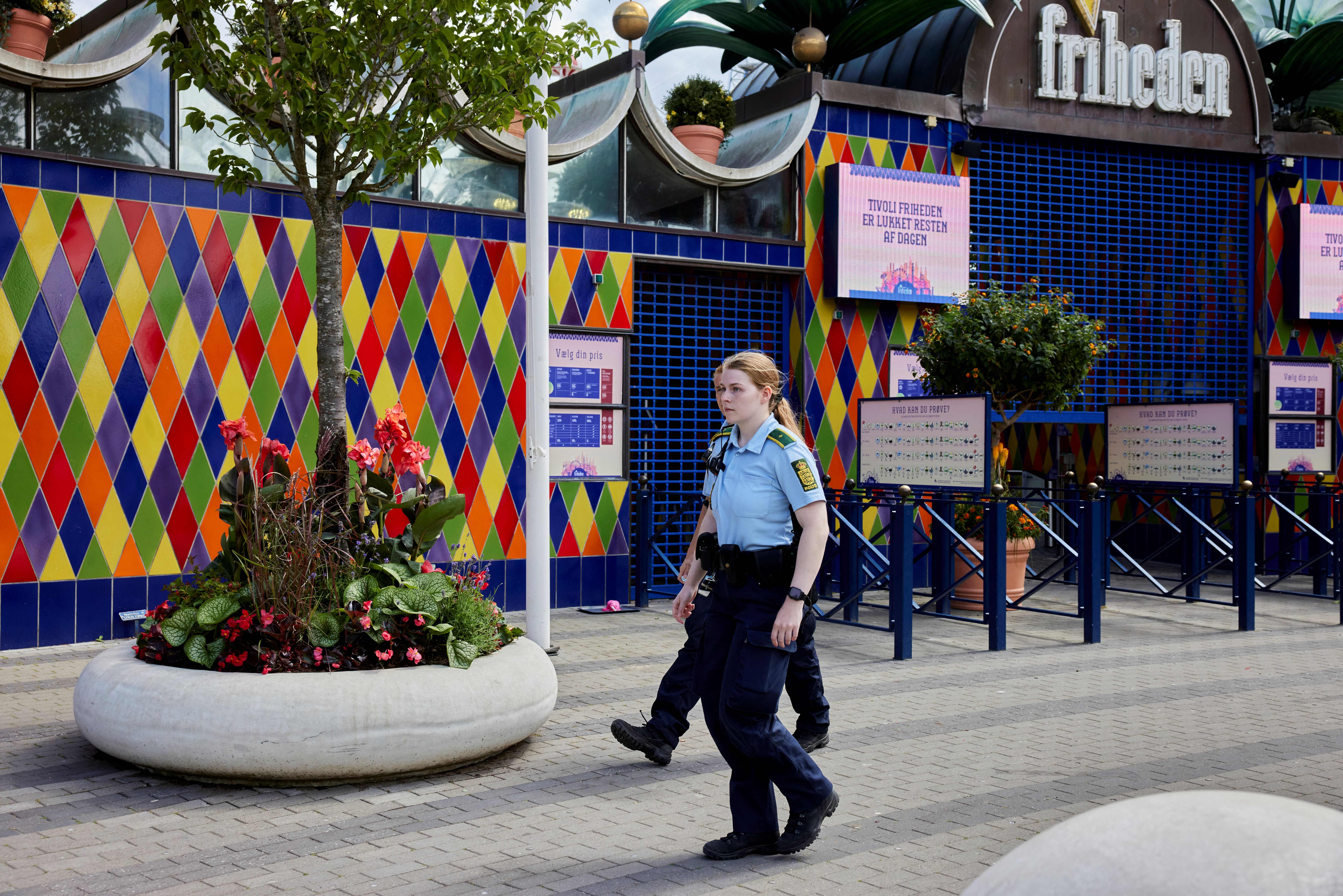 Police walk outside the closed Tivoli Friheden amusement park, in Aarhus, western Denmark on 14 July 2022