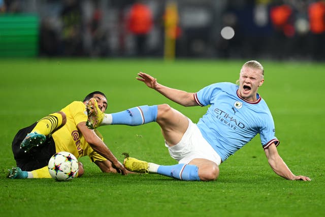 <p>Erling Haaland is challenged by Dortmund’s Emre Can</p>
