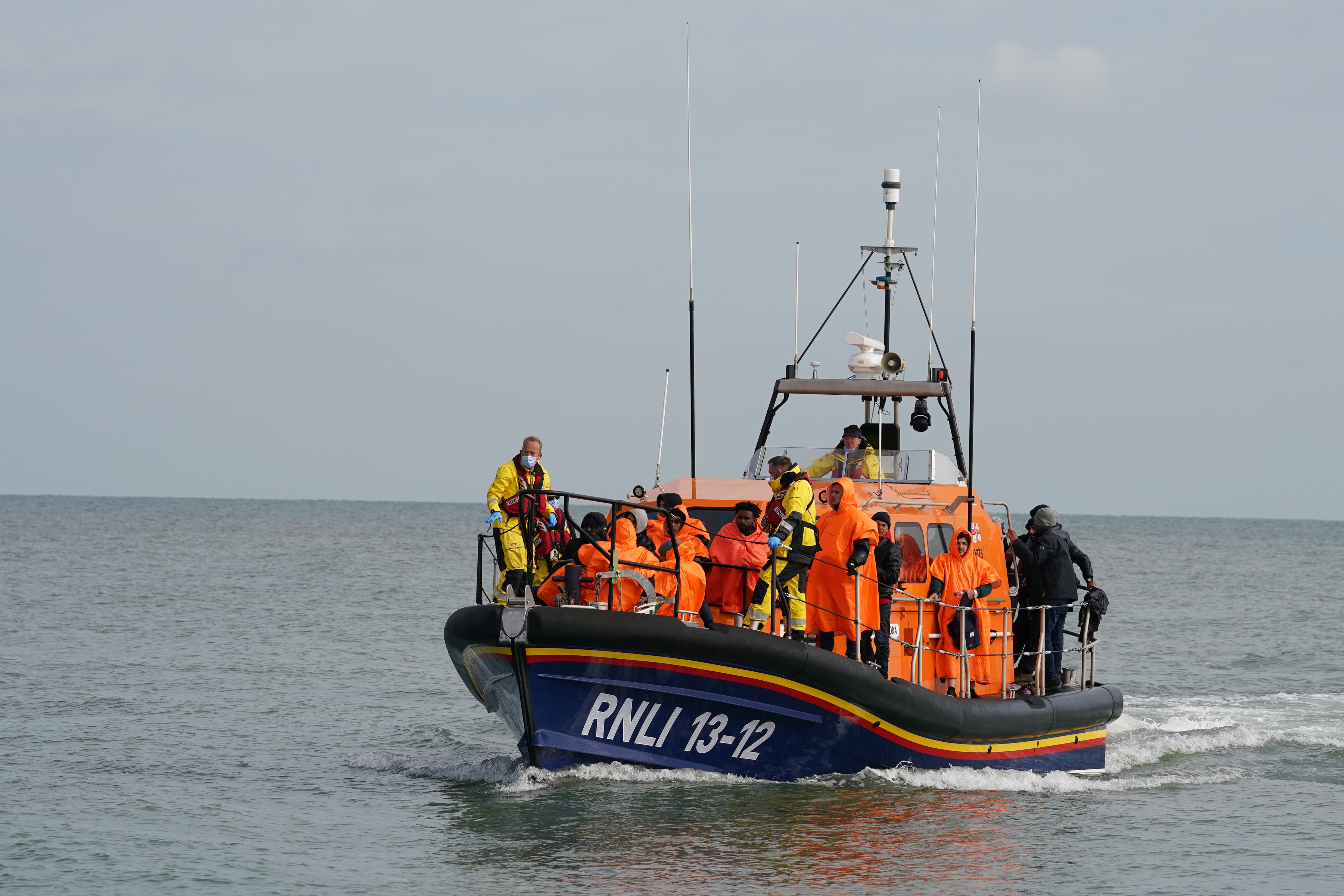 A group of people thought to be migrants are brought in to Dungeness beach by the Dungeness lifeboat following a small boat incident in the Channel. Picture date: Wednesday October 12, 2022 (Gareth Fuller/PA)