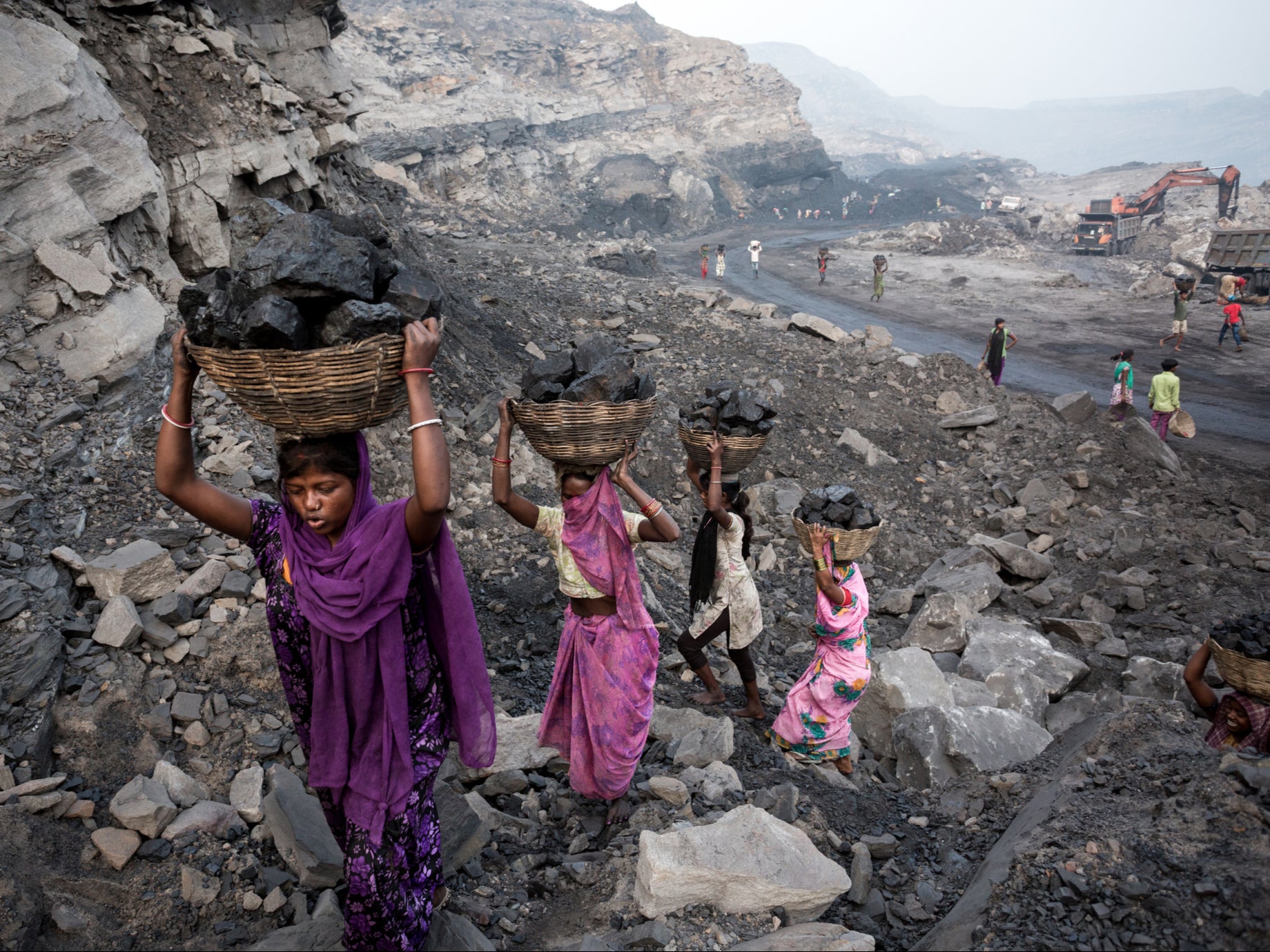 Girls collect coal from a mine in Dhanbad, India, in 2019