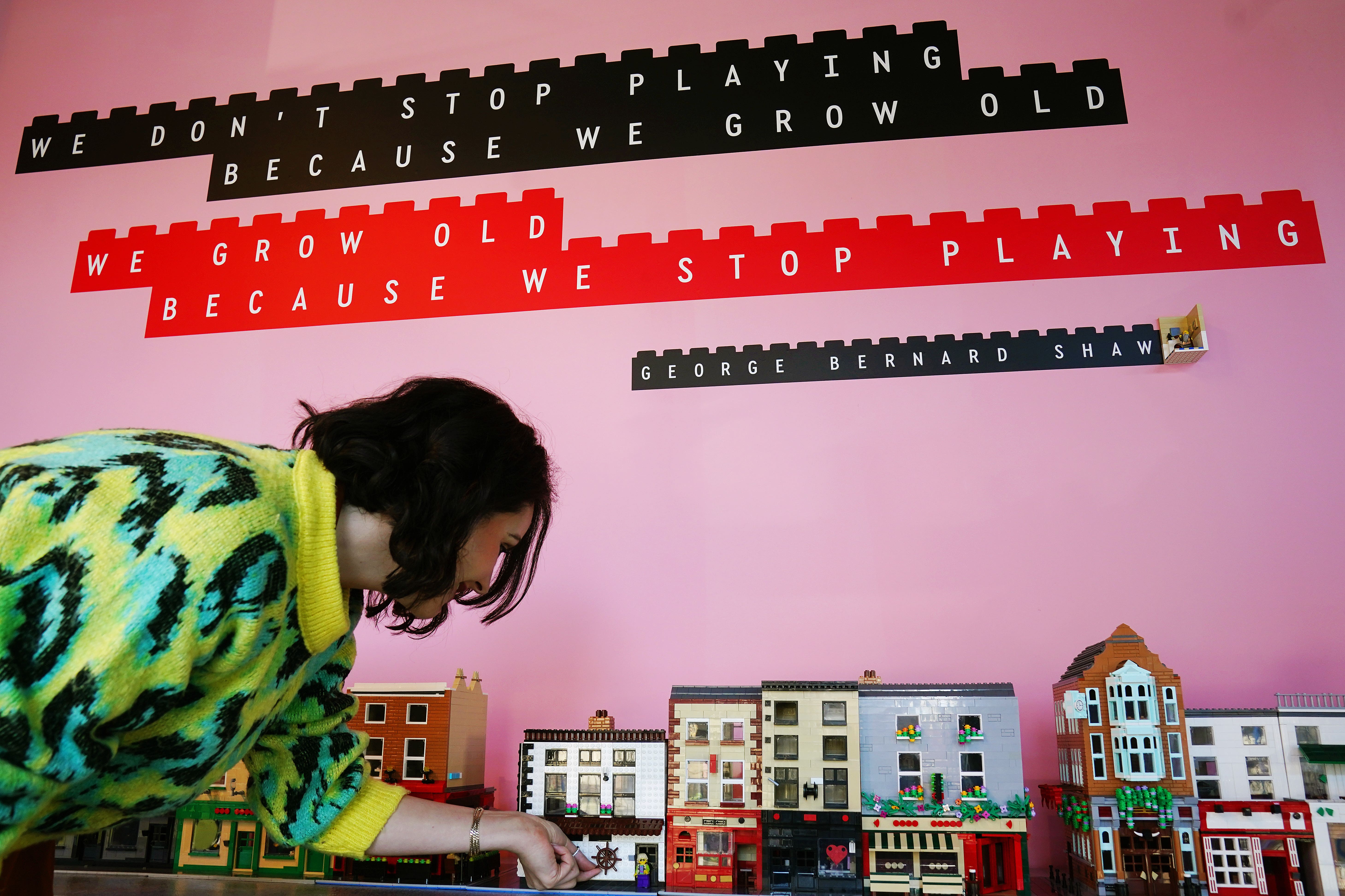 Karleen Smyth of Boys + Girls and EXP arranges models of Dublin pubs at the opening of the world’s first experimental Lego Brick Cafe in Dublin city centre (Brian Lawless/PA)