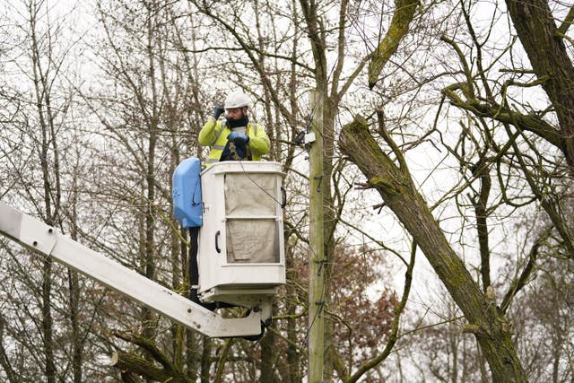 An engineer fixes telephone lines brought down by Storm Arwen (Danny Lawson/PA)