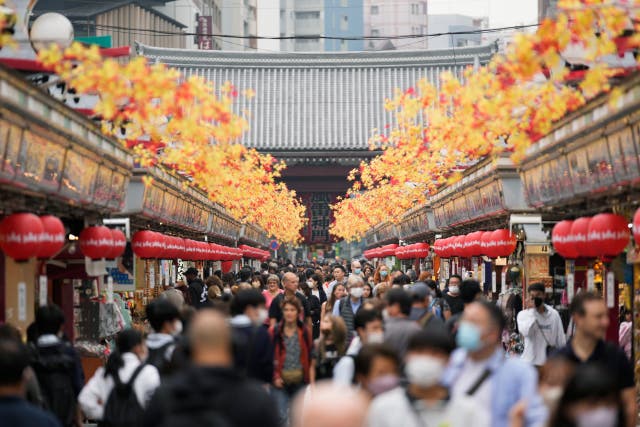 <p>Tourists walk through a promenade lined with souvenir shops leading to the Sensoji Buddhism temple in the famed Asakusa district of Tokyo </p>