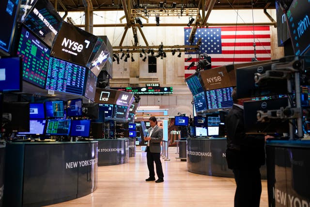 <p>Traders work on the floor at the New York Stock Exchange in New York</p>