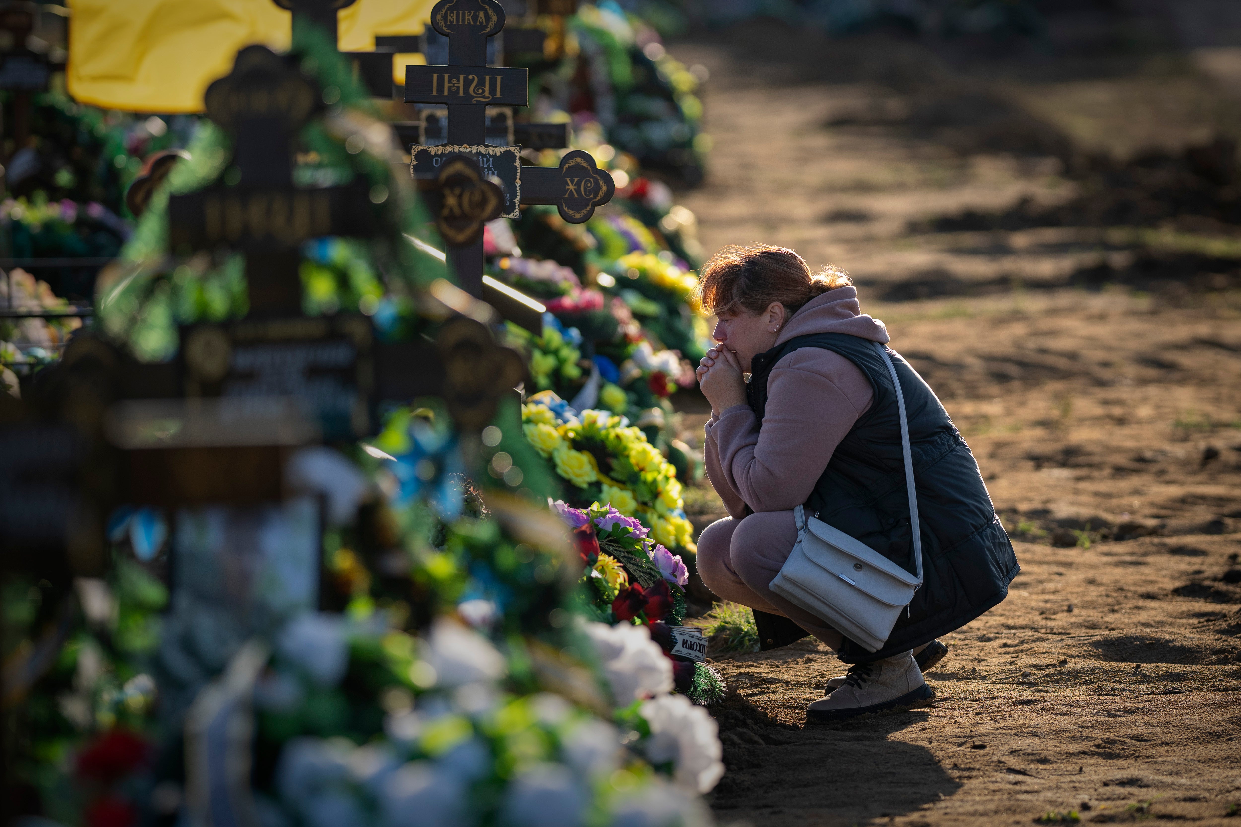 Tamara, 50, mourns at the grave of her only son, a military servicemen killed during a Russian bombing raid