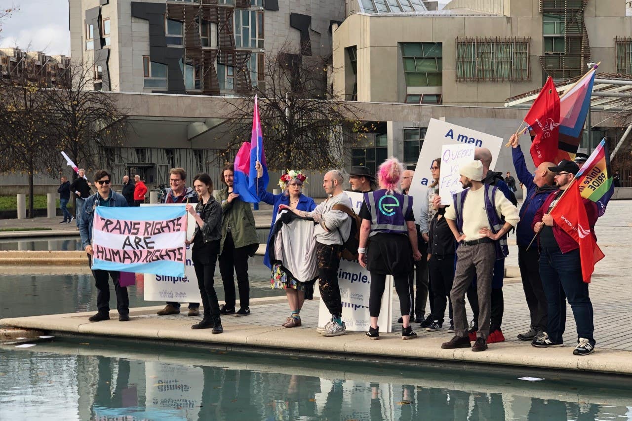 Scottish Trans supporters sought to cover up opposing protesters’ signs (Neil Pooran/PA)