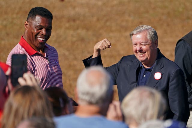 <p>Republican candidate for U.S. Senate Herschel Walker, left, and Sen. Lindsey Graham, R-S.C., gesture to the crowd as they arrive for a campaign stop in Cumming, Ga., Thursday, Oct. 27, 2022</p>