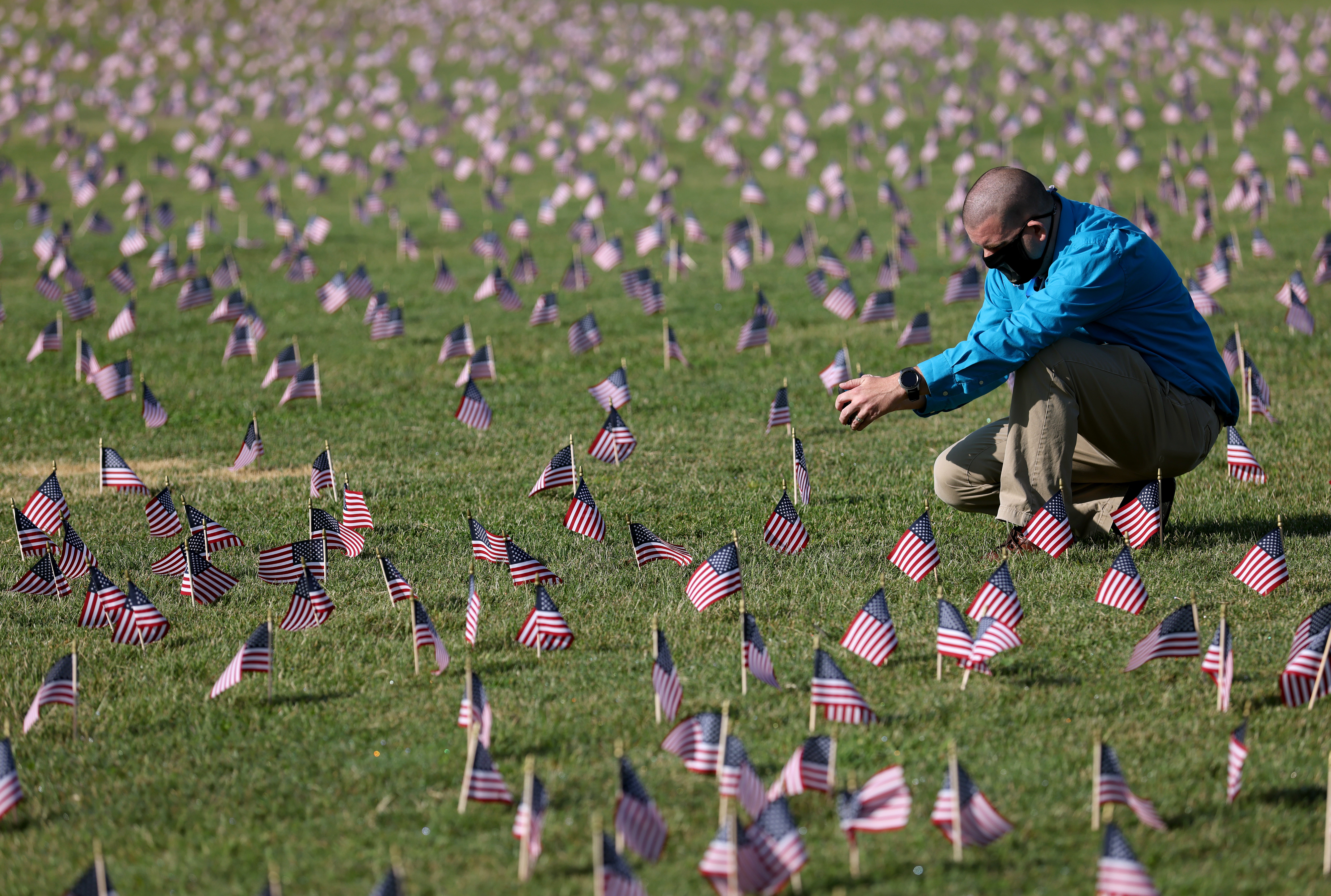 Chris Duncan, whose 75 year old mother Constance died from Covid on her birthday, photographs a Covid Memorial Project installation of 20,000 American flags on the National Mall in Washington, DC