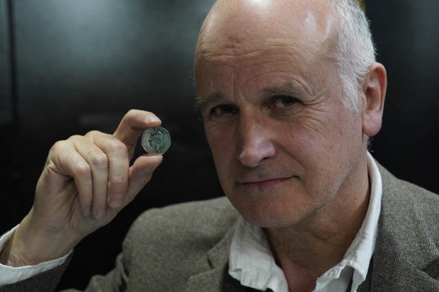 Artist Martin Jennings with one of the coins (Alistair Heap/PA)
