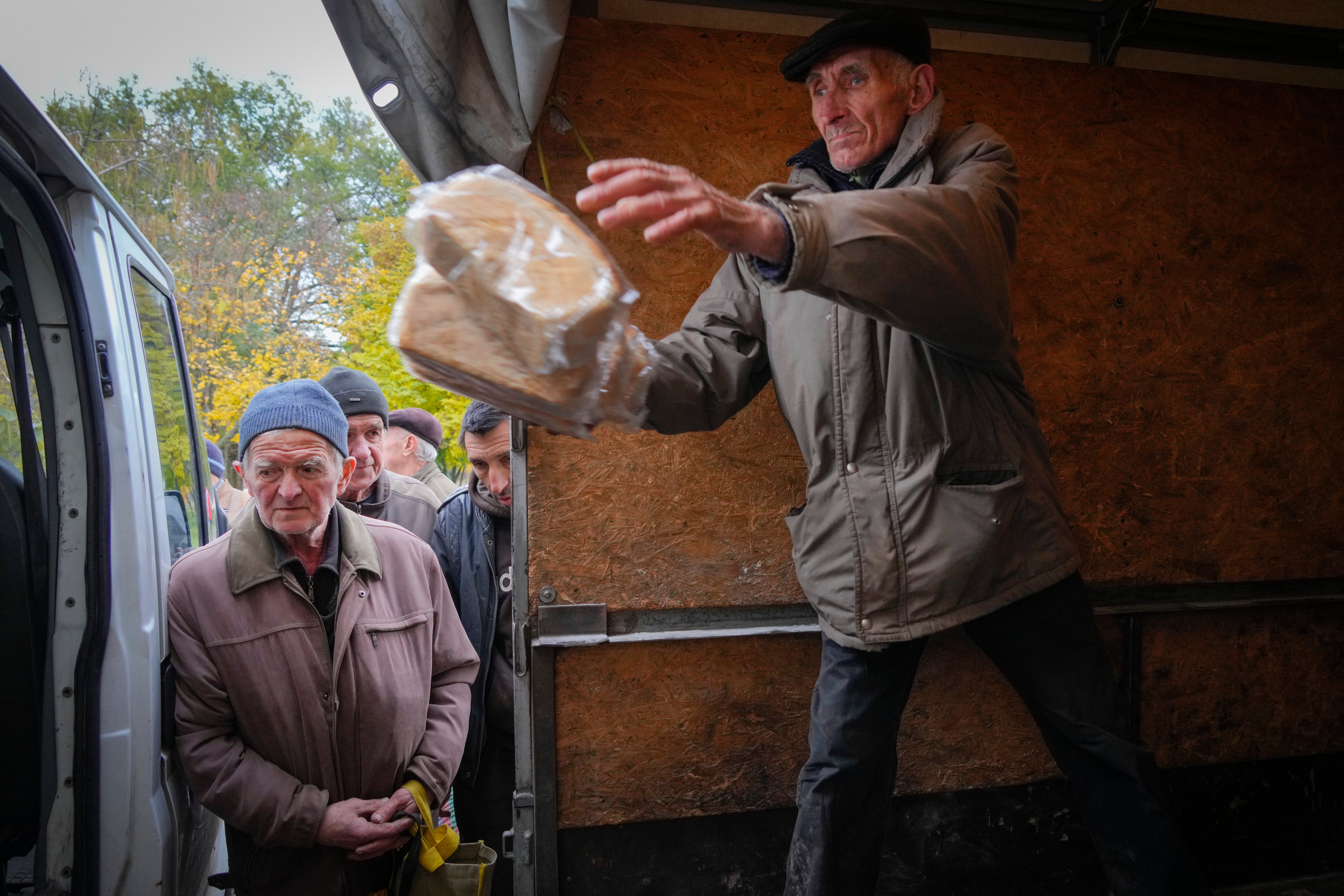 A volunteer unloads bread for free distribution in Bakhmut, Donetsk