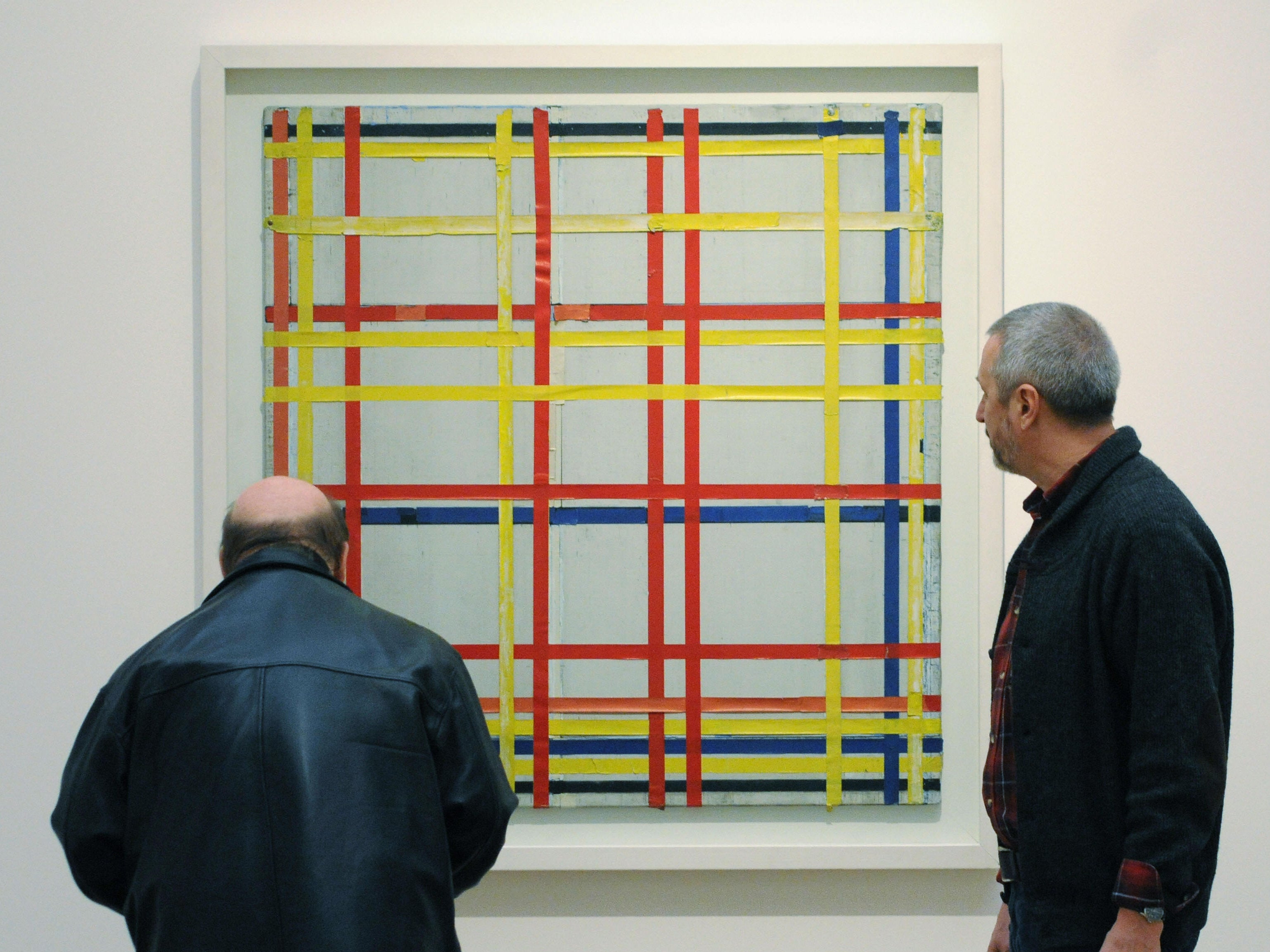 Two visitors look at ‘New York City 1 (unfinished)’ by Piet Mondrian at the Museum Ludwig in Cologne, western Germany