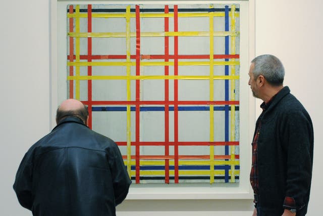 <p>Two visitors look at ‘New York City 1 (unfinished)’ by Piet Mondrian at the Museum Ludwig in Cologne, western Germany</p>