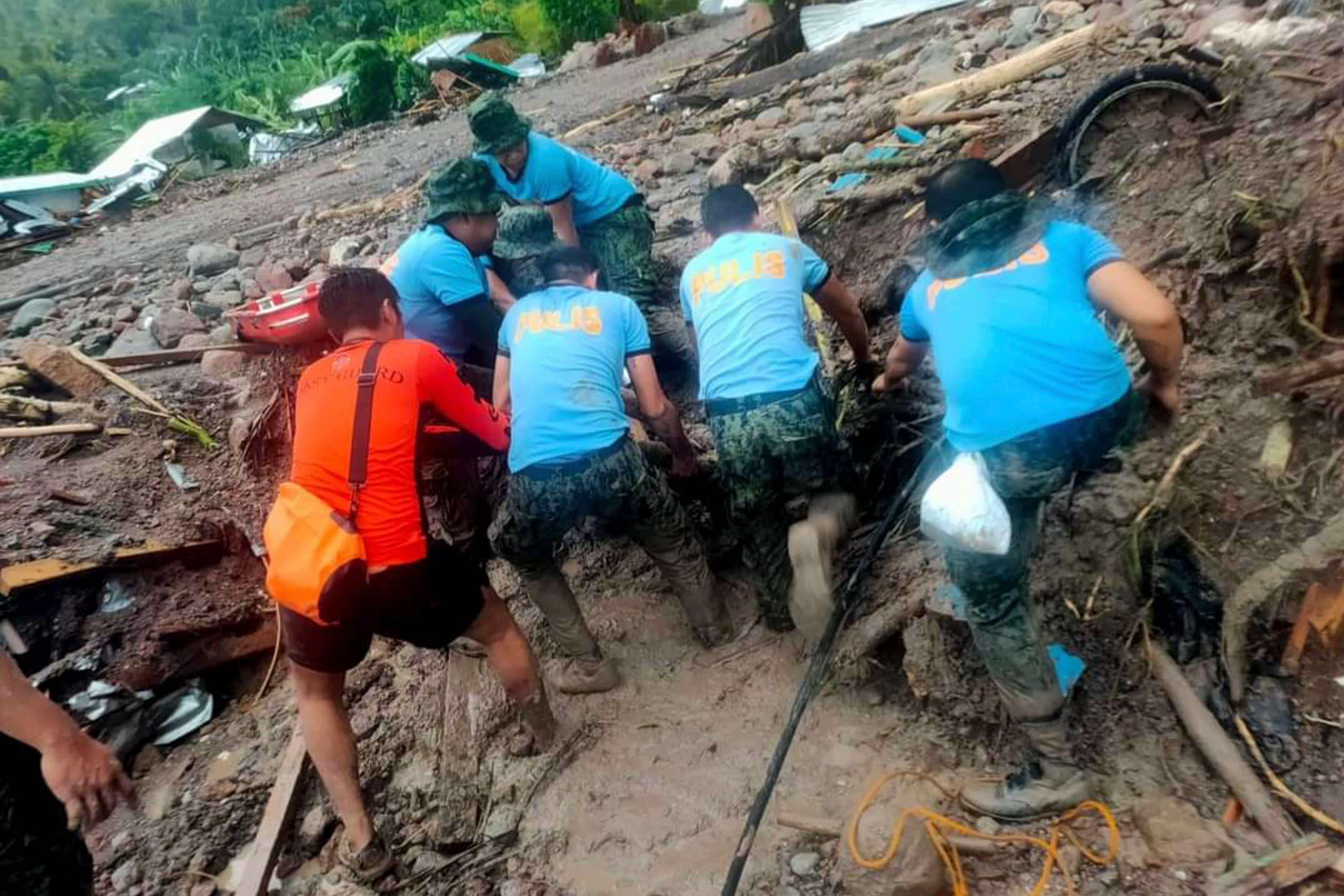 Rescuers retrieve bodies amid landslides caused by tropical storm Nalgae in Maguindanao province, southern Philippines