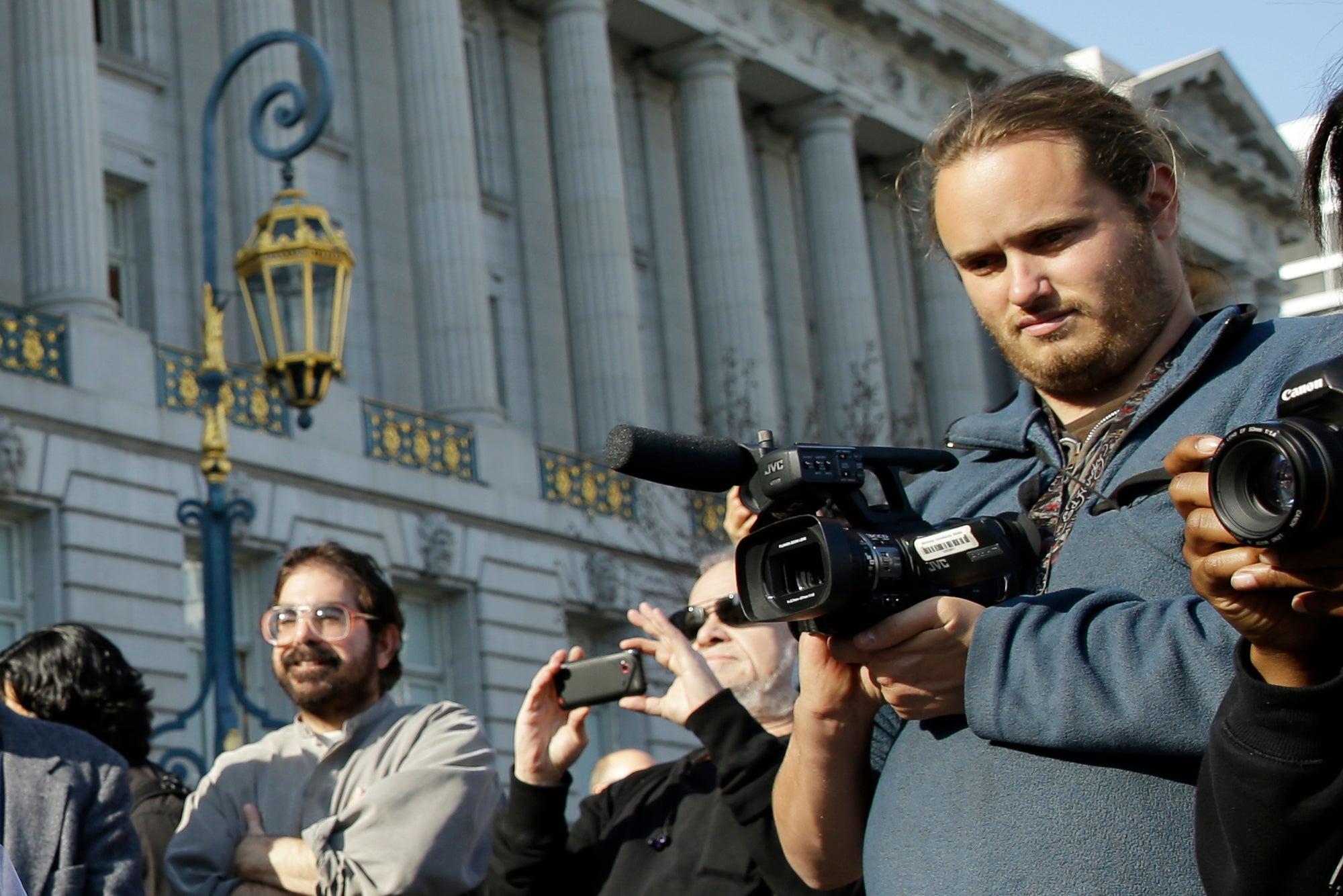 David DePape, right, records the nude wedding of Gypsy Taub outside City Hall on Dec. 19, 2013, in San Francisco
