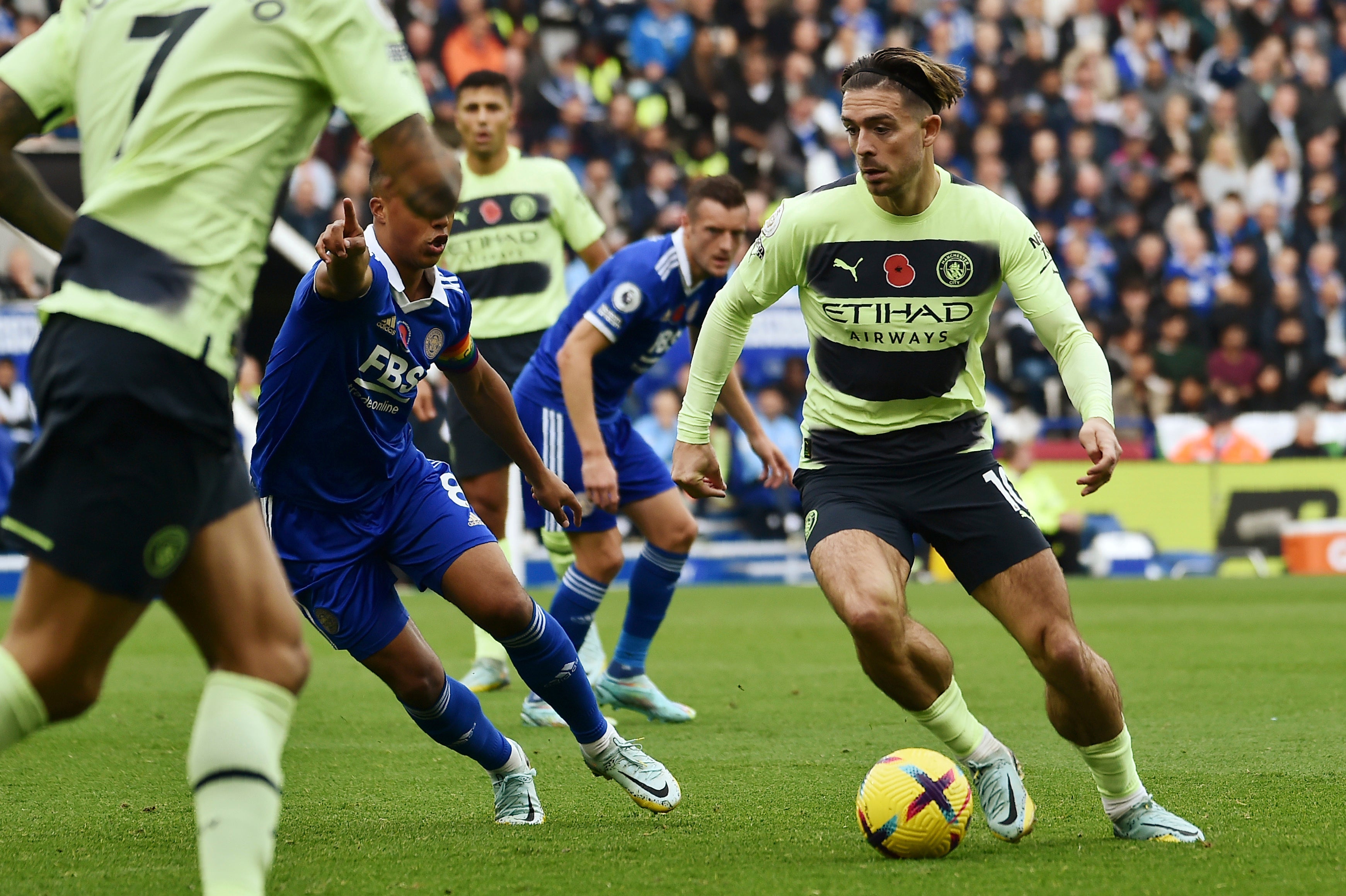 Manchester City's Jack Grealish, right, challenges for the ball with Leicester's Youri Tielemans