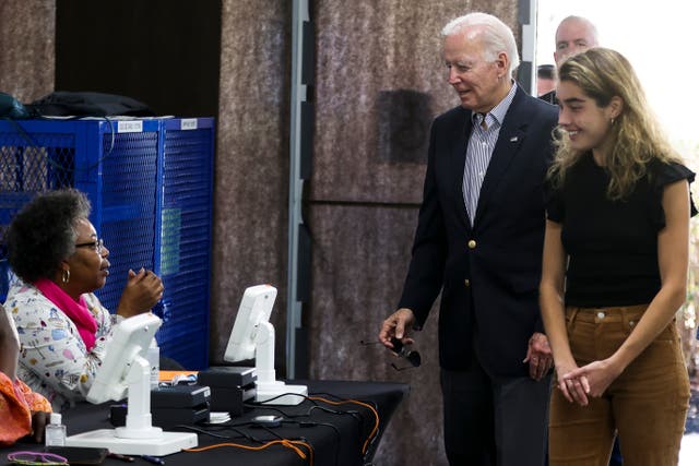 <p>President Joe Biden arrives to cast his vote during early voting for the 2022 U.S. midterm elections with his granddaughter </p>