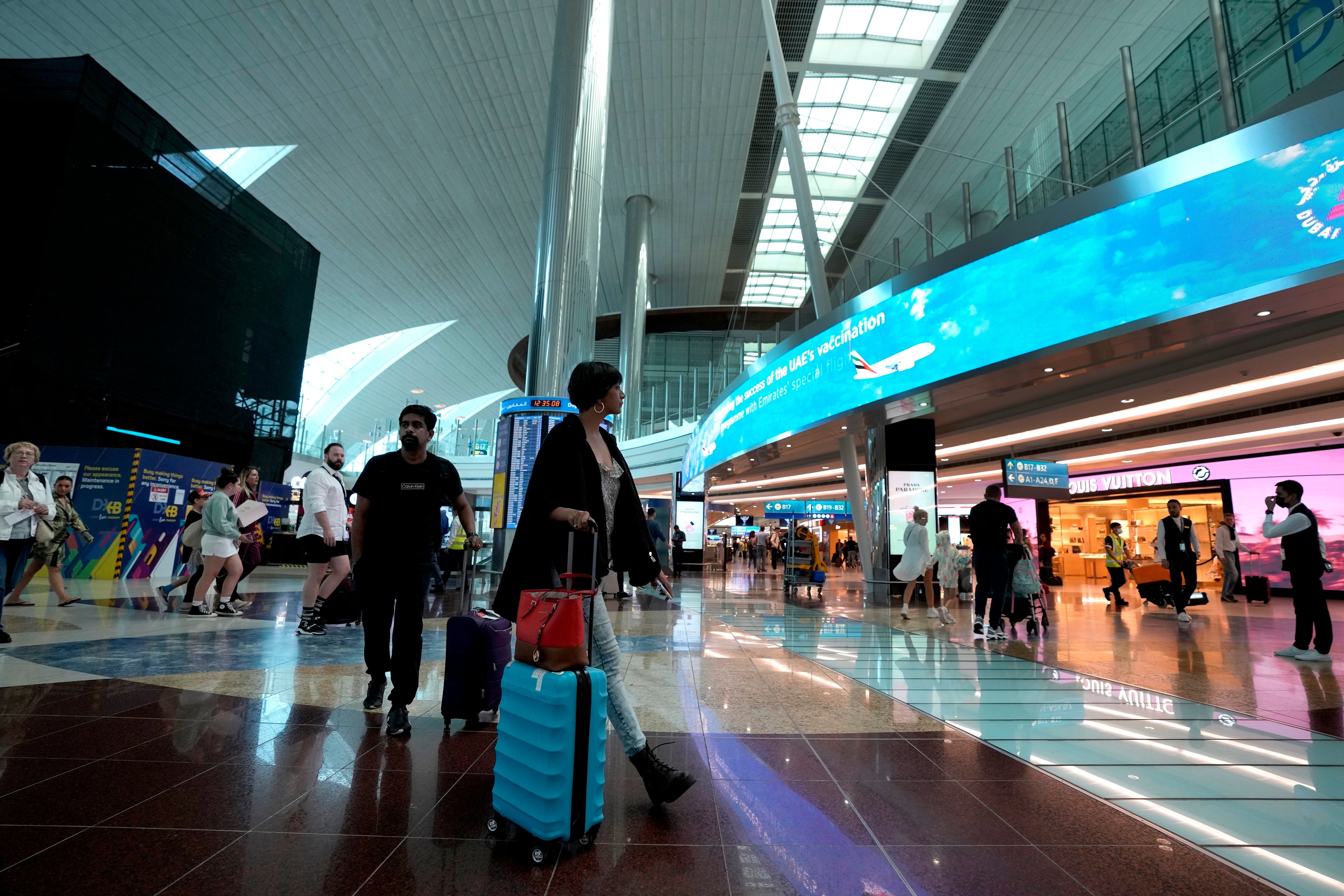 Keeping busy: Passengers at Dubai international airport