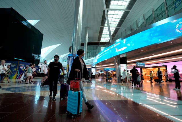 <p>Keeping busy: Passengers at Dubai international airport </p>