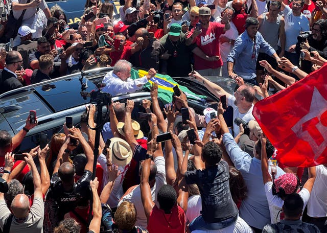 <p>Brazil’s presidential candidate Luiz Inacio Lula da Silva greets supporters after casting his vote on the outskirts of Sao Paulo</p>