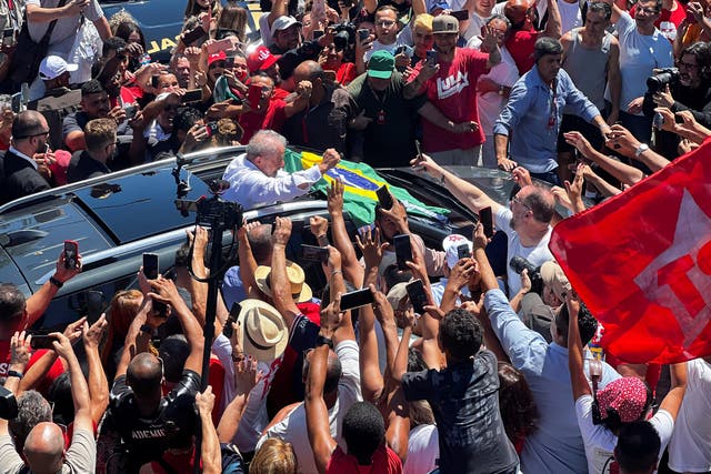 <p>Brazil’s presidential candidate Luiz Inacio Lula da Silva greets supporters after casting his vote on the outskirts of Sao Paulo</p>