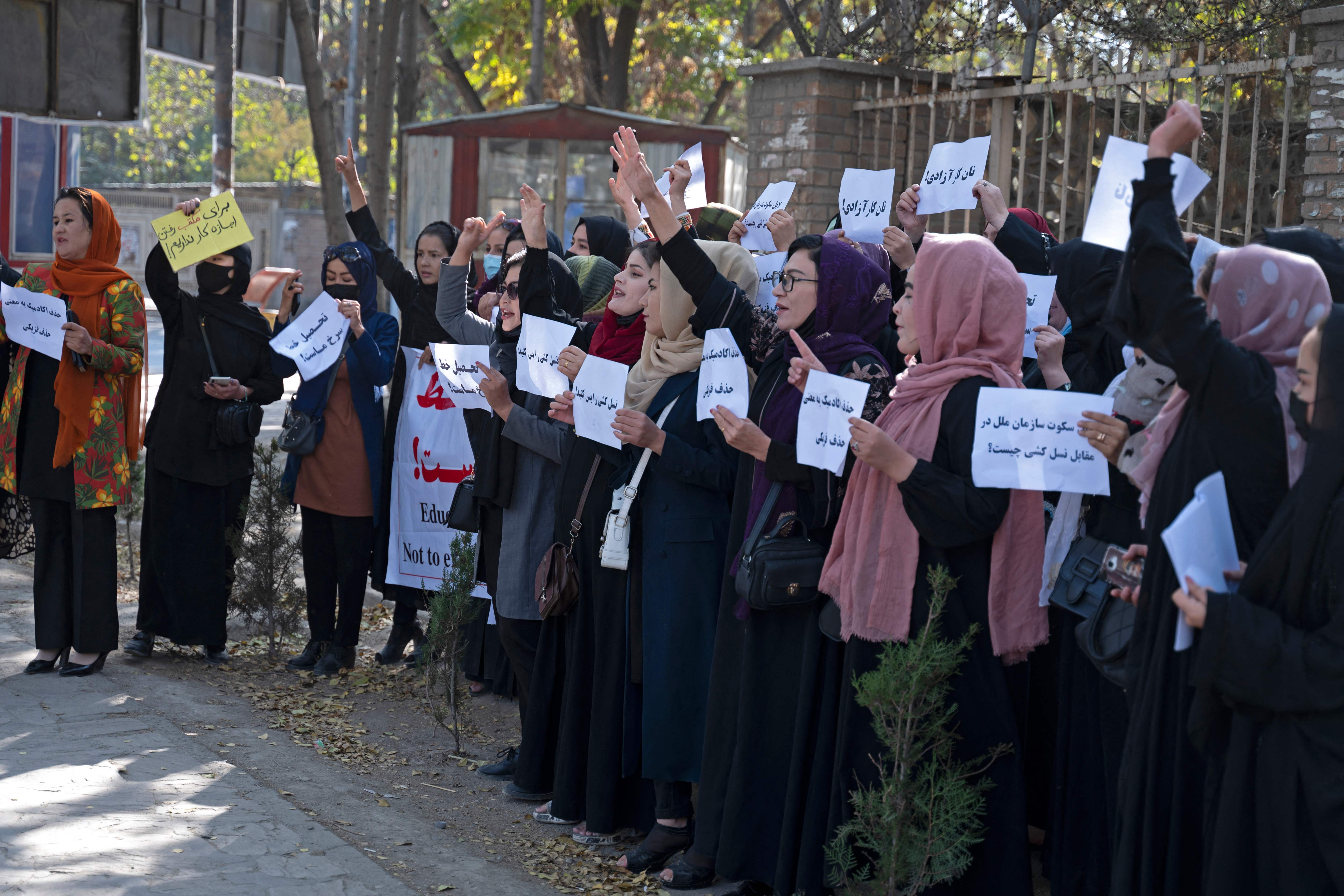 <p>Afghan women hold placards during a protest in front of Kabul University</p>