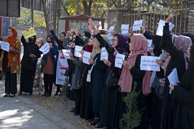 <p>Afghan women hold placards during a protest in front of Kabul University</p>