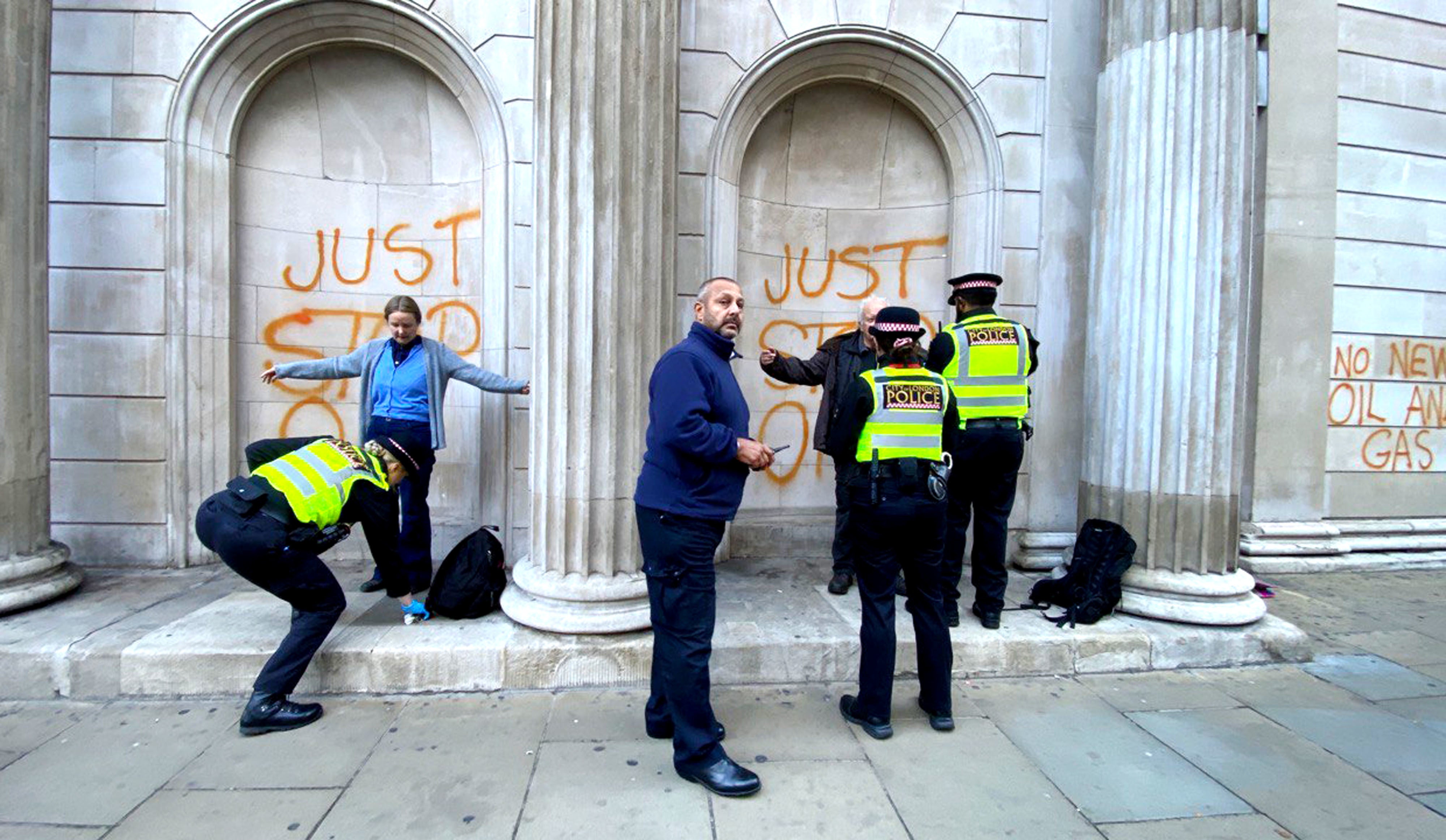 Protesters sprayed orange paint on a number of buildings in London on Monday