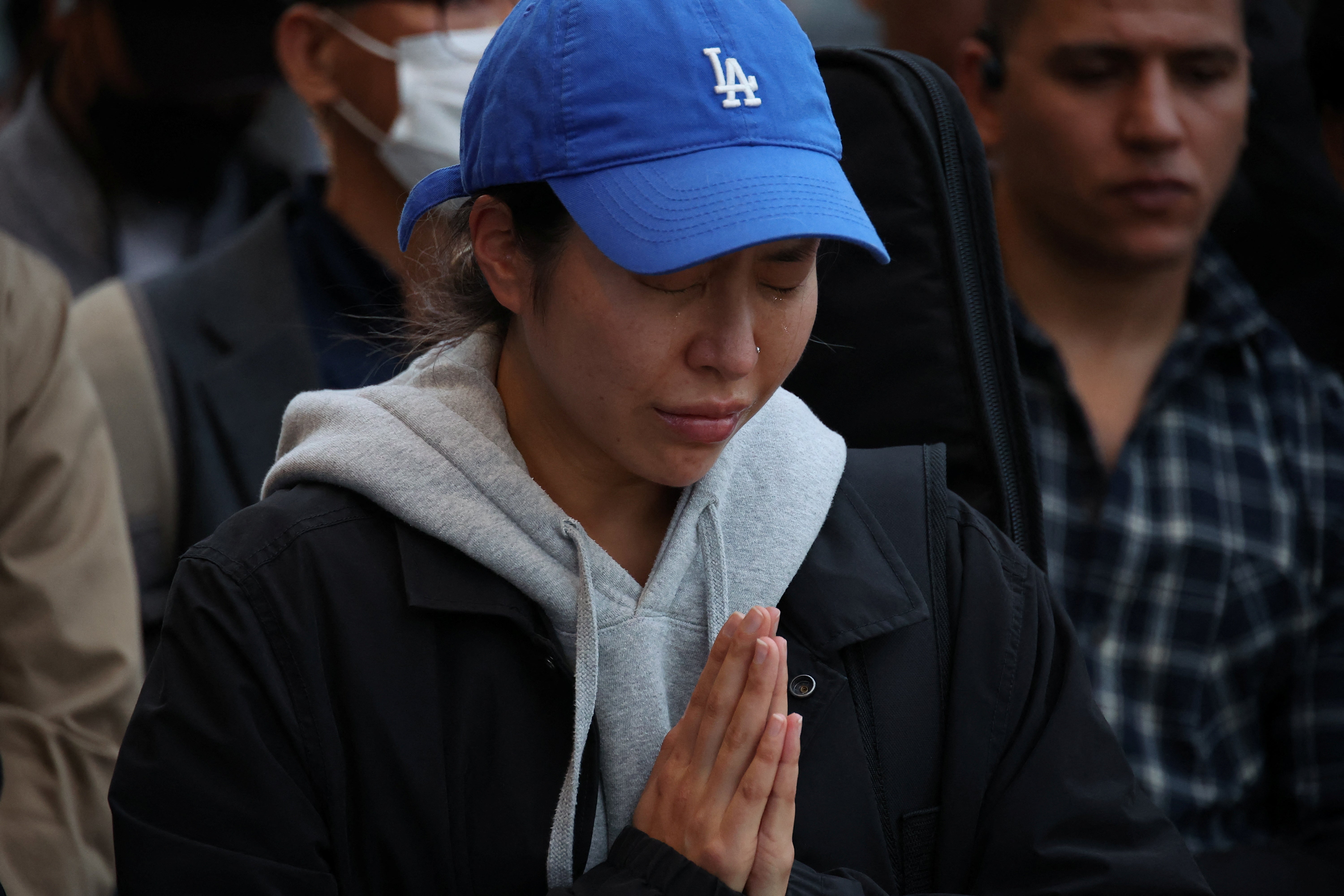 A woman pays respects near the scene of a crowd crush