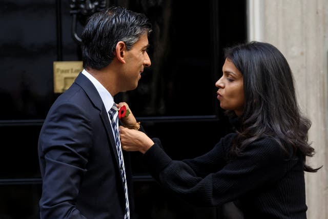 <p>Akshata Murty puts a poppy pin on her husband prime minister Rishi Sunak as they meet volunteers from the Royal British Legion </p>