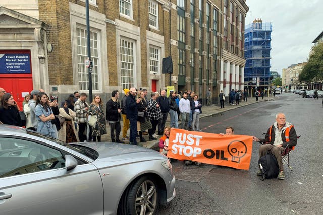 <p>Just Stop Oil activists blocking the road on Commercial Street in east London</p>