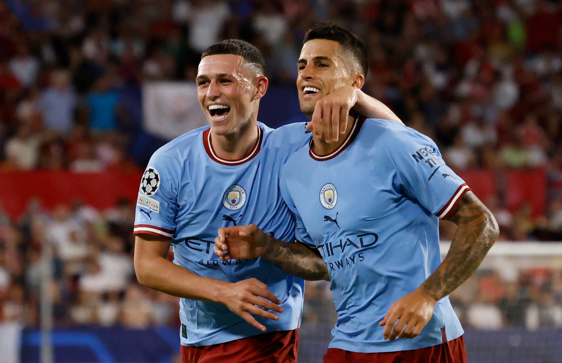 Phil Foden celebrates scoring Manchester City’s second goal agains Seville with Joao Cancelo