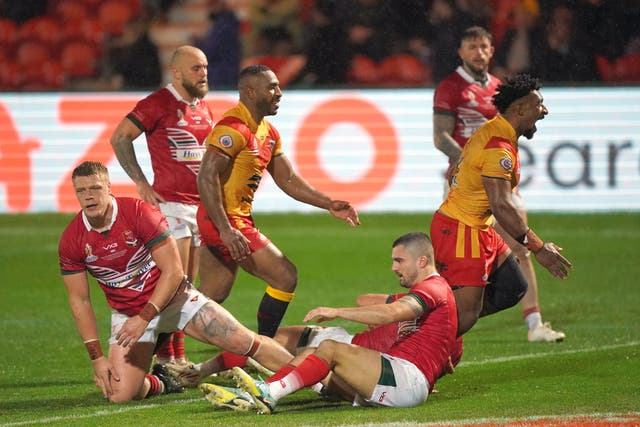 Papua New Guinea’s Nixon Putt, right, celebrates a try (Tim Goode/PA)