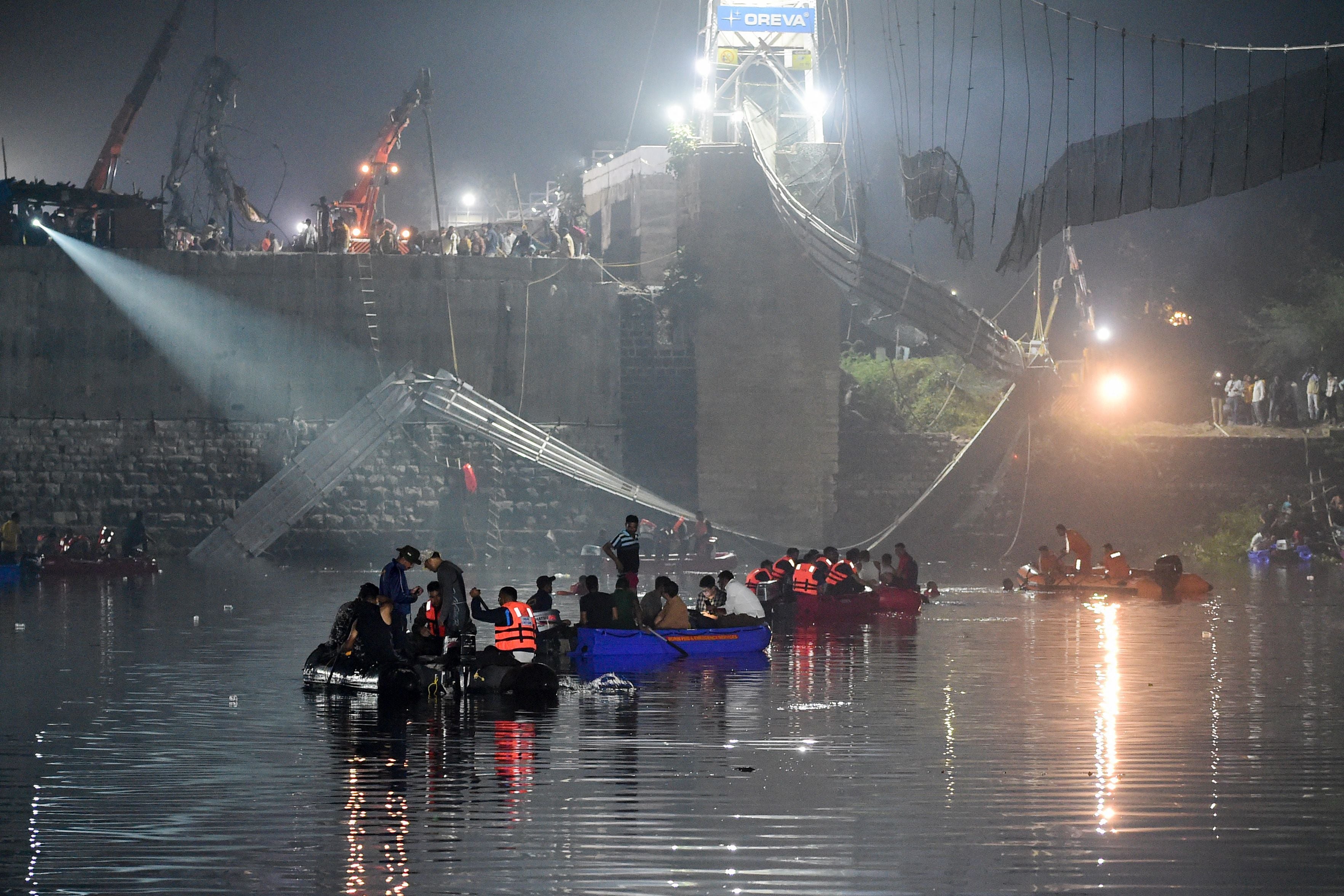 Indian rescue personnel conduct search operations after the bridge collapse