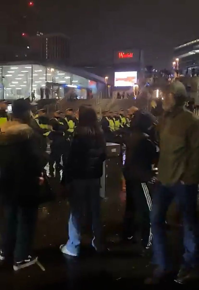 Officers form a barrier moving youths out of the area