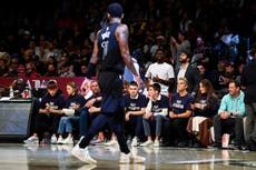 Fans in 'Fight Antisemitism' shirts courtside at Nets game