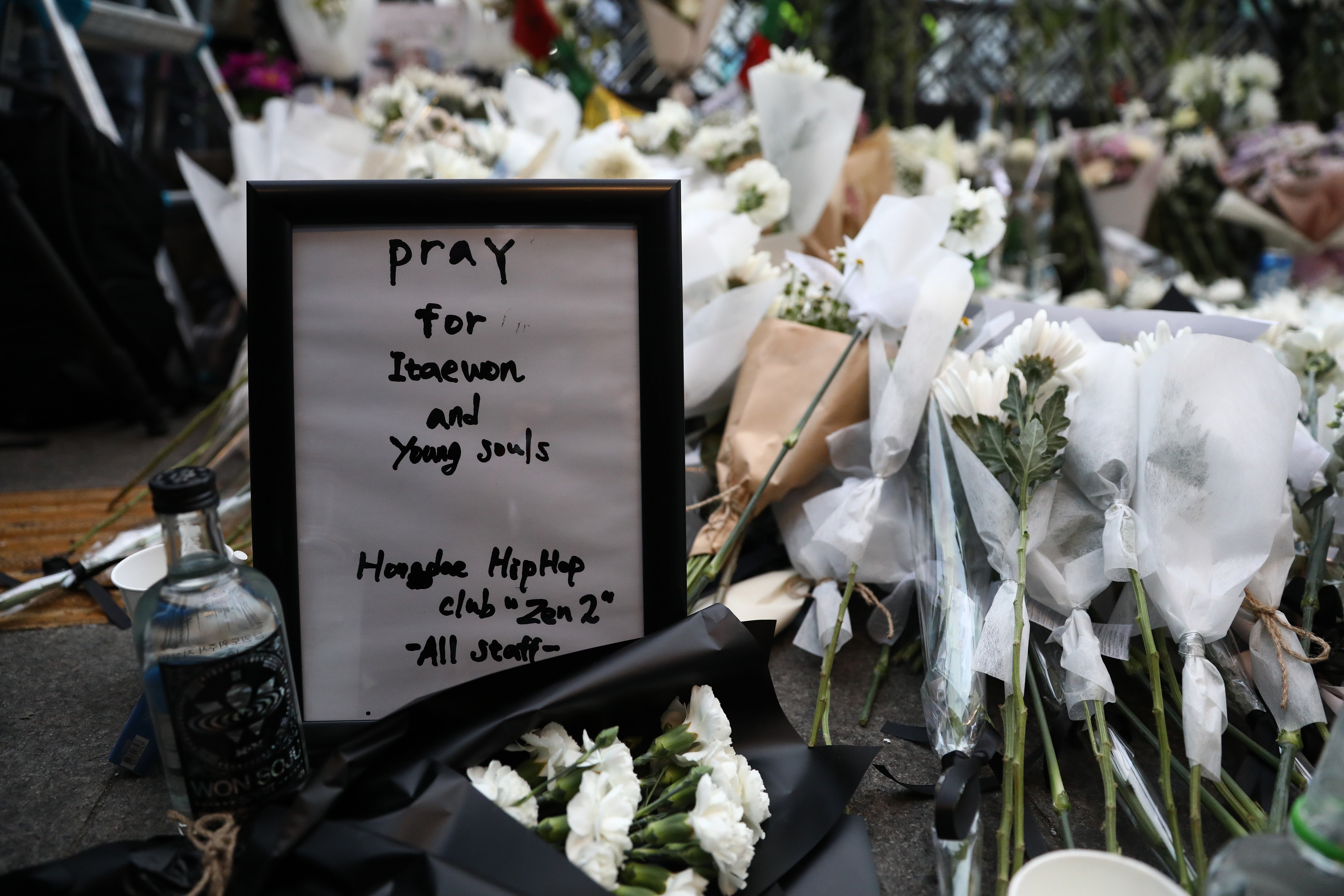 A woman pays tribute for the victims of the Halloween celebration stampede, on the street near the scene on 31 October 2022 in Seoul, South Korea