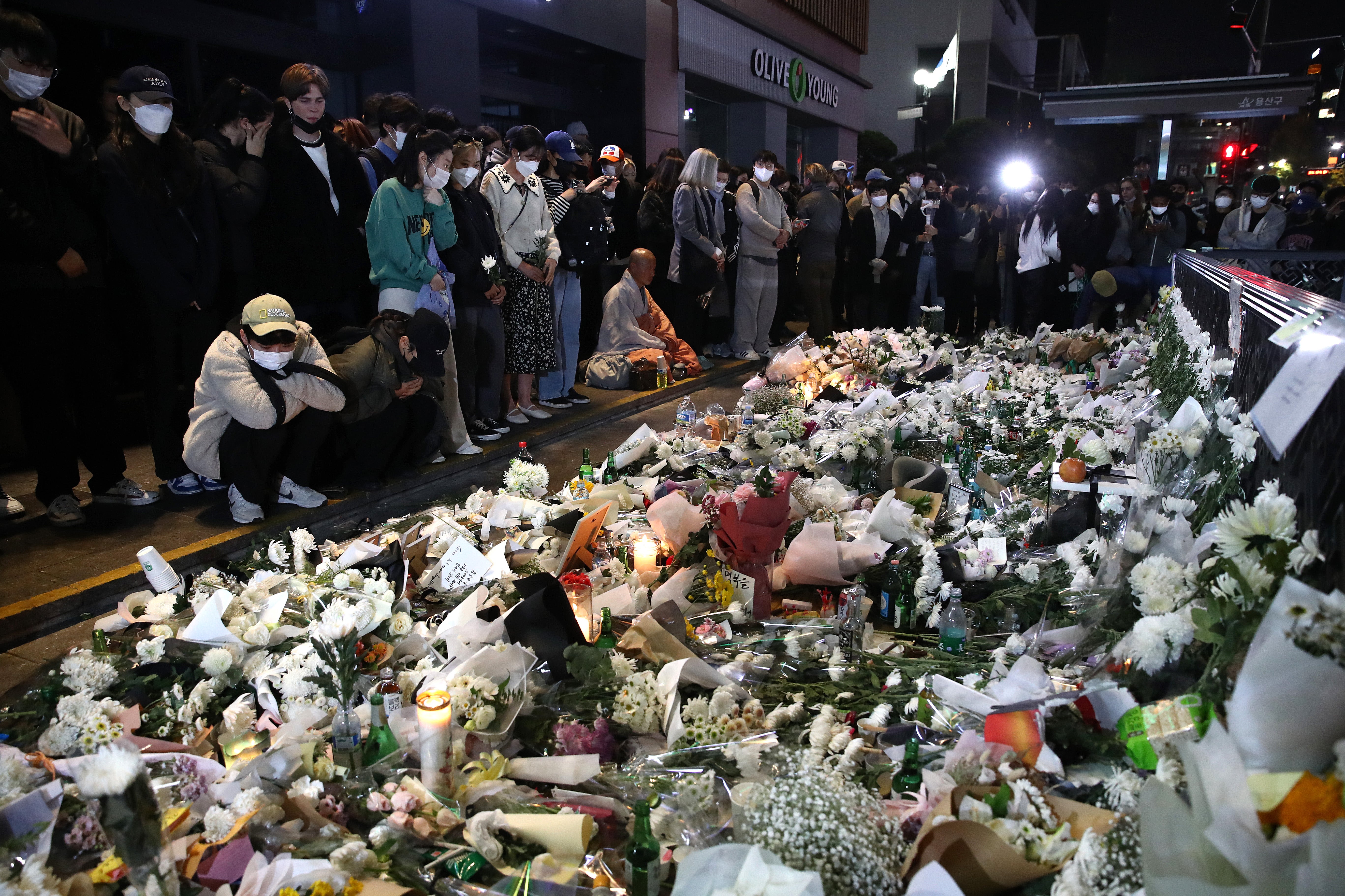 People pay tribute for the victims of the Halloween celebration stampede, on the street near the scene on 31 October 2022 in Seoul, South Korea