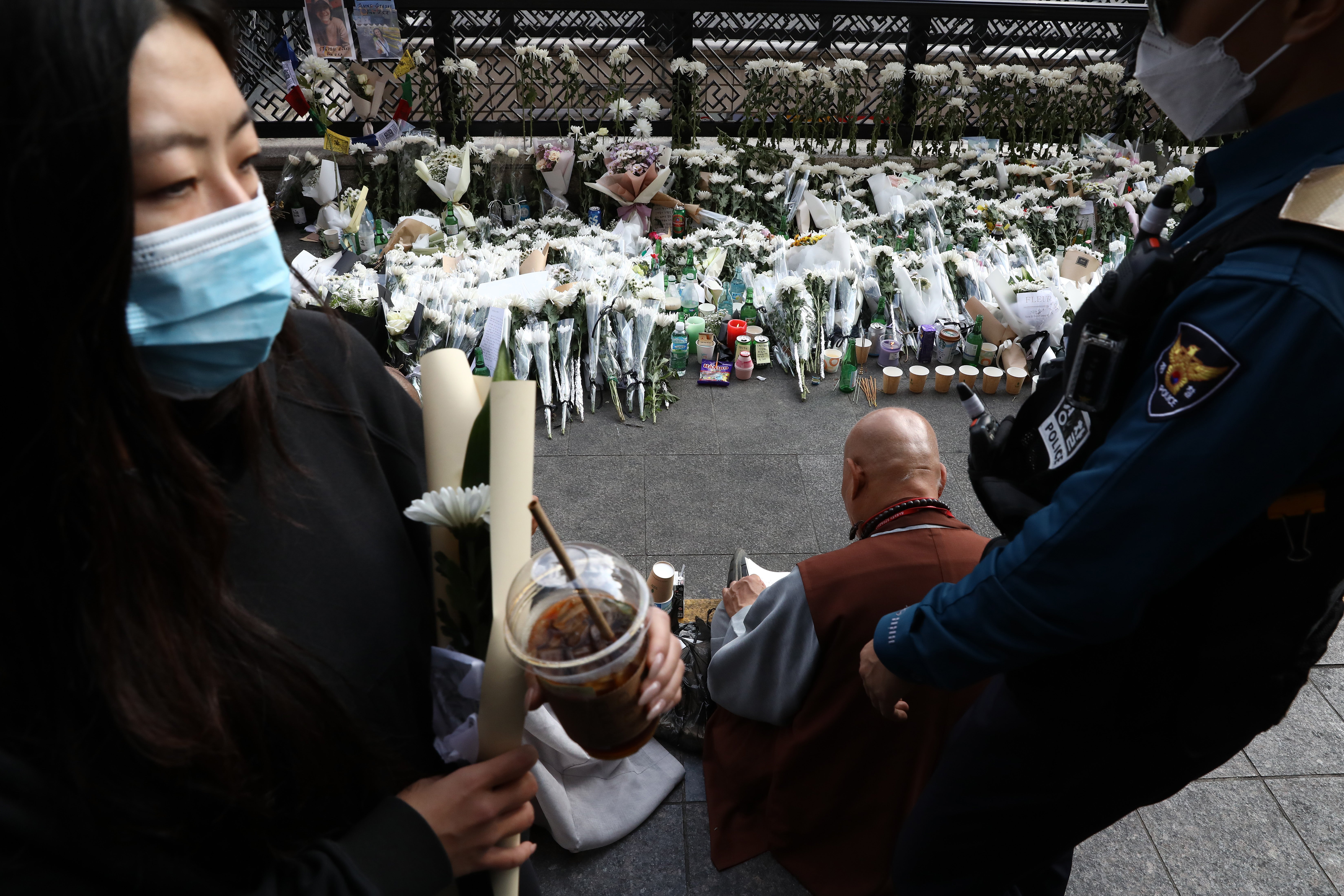 Monks pay tribute for the victims of the Halloween celebration stampede, on the street near the scene on 31 October 2022 in Seoul, South Korea