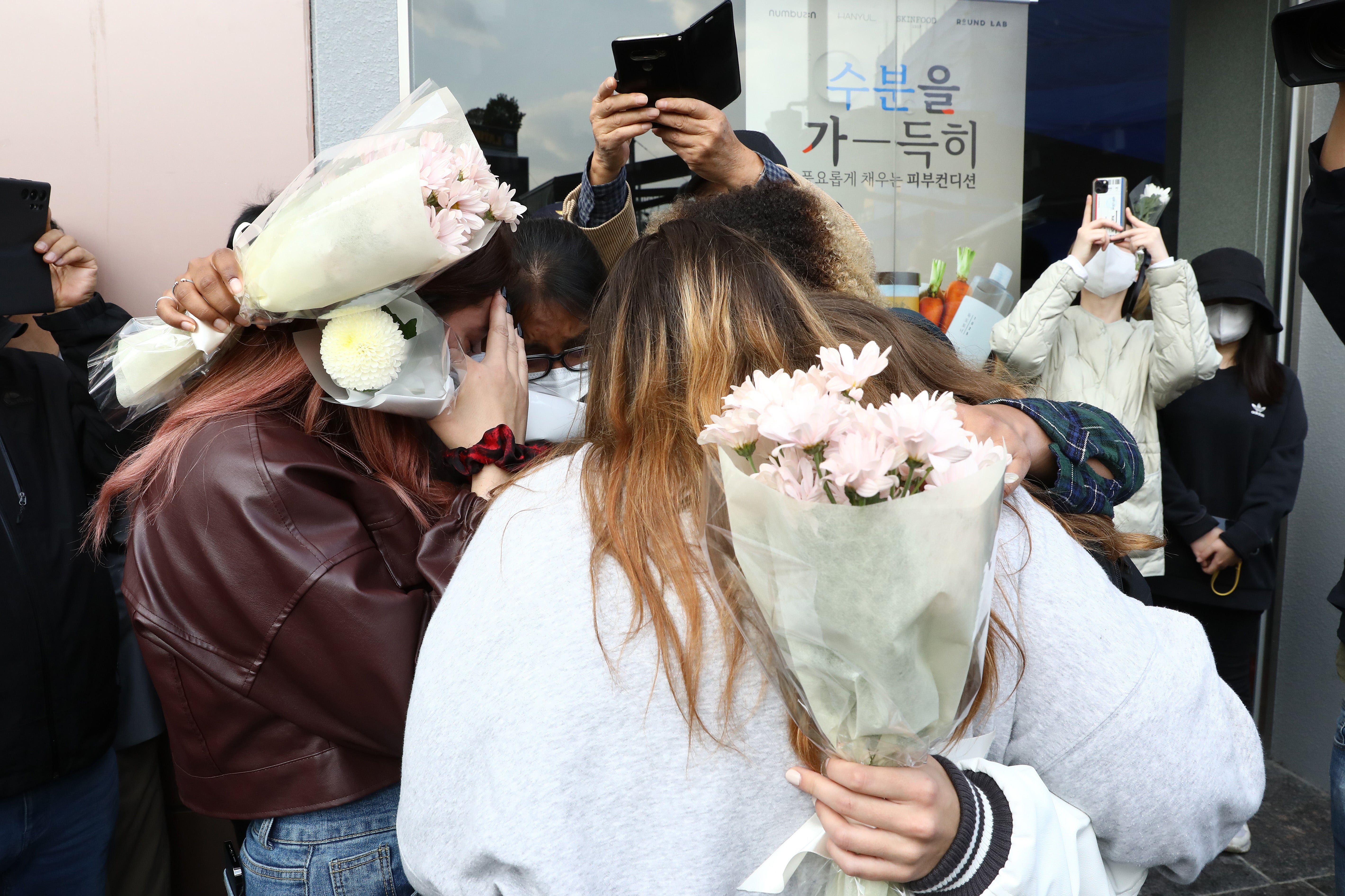 People pay tribute for the victims of the Halloween celebration stampede, on the street near the scene on 31 October 2022 in Seoul, South Korea